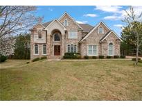 Stately two-story brick home featuring arched windows and manicured front lawn at 4402 Income Cir, Ellenwood, GA 30294