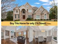 Elegant, multi-story stone house featuring a meticulously landscaped yard and a welcoming, arched entryway at 4402 Income Cir, Ellenwood, GA 30294