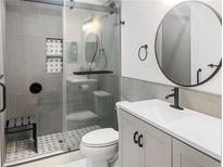 This modern bathroom features a glass shower door, black fixtures, and sleek vanity at 475 Mount Vernon Ne Hwy # 226C, Atlanta, GA 30328