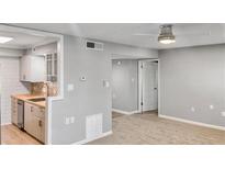 Open-concept living room featuring updated kitchen view and neutral color palette, promoting bright living at 475 Mount Vernon Ne Hwy # 226C, Atlanta, GA 30328
