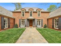 Stunning brick home with manicured lawn and symmetrical design, offering classic charm and curb appeal at 4195 Woodland Brook Se Dr, Atlanta, GA 30339