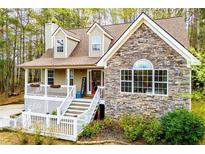 Charming home with stone and siding exterior, inviting front porch, and manicured landscaping at 9176 Lakeview Parkway, Villa Rica, GA 30180