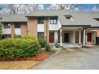 Charming townhome with brick facade, carport, and well-maintained landscaping at 3259 Clairmont North Ne, Brookhaven, GA 30329