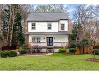 Charming two-story home with a well-manicured lawn and inviting front porch at 3991 Centennial Trl, Duluth, GA 30096
