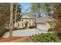 Charming two-story home featuring a spacious driveway and attached two-car garage at 535 Telford Pl, Atlanta, GA 30342