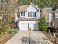 Charming two-story home with a two-car garage, manicured landscaping, and inviting curb appeal at 750 Mountain Laurel Dr, Canton, GA 30114