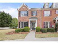 Charming brick townhome with manicured landscaping and black shutters offers classic curb appeal at 1754 Heights Nw Cir # 11, Kennesaw, GA 30152