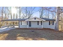 Charming single-story home with a covered carport and well-maintained front yard at 5496 Davis Dr, Austell, GA 30106