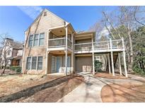 Exterior view of a two-story condo with balconies and a sidewalk leading to the entrance at 602 Abingdon Way, Atlanta, GA 30328