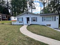 Charming single-story home featuring a well-manicured lawn and a welcoming walkway at 2747 Santa Barbara Nw Dr, Atlanta, GA 30318