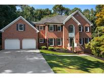 Beautiful two-story brick home with a well-manicured lawn and two-car garage at 13 Sherman Nw Ln, Cartersville, GA 30121