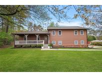 Charming two-story home with a welcoming front porch and well-manicured lawn, perfect for Gathering living at 3916 S Martin Way, Lithia Springs, GA 30122