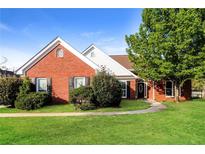 Charming single-story brick home featuring a lush lawn, well-maintained landscaping, and inviting front entrance at 4820 Camden Sw Dr, Conyers, GA 30094