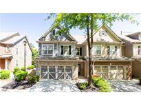 Charming townhome with stone accents, a two-car garage, and manicured landscaping at 5715 Keys Way, Lithonia, GA 30058