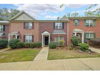 Charming brick townhome with black shutters, manicured lawn, and inviting front entrance at 3729 Town Square Nw Cir # 6, Kennesaw, GA 30144