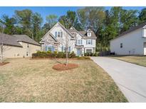 Charming two-story home with stone accents, blue shutters, and a well-manicured lawn at 3087 Mountain Shadow Way, Marietta, GA 30064