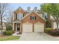 Charming red brick home featuring a two-car garage and manicured landscaping at 1680 Fair Oak Way # 24, Mableton, GA 30126