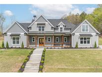 Charming two-story home featuring a welcoming front porch and beautifully landscaped front yard at 3068 Turning Creek Trail, Dacula, GA 30019
