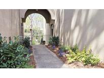 Charming walkway leading to the entrance, enhanced by lush greenery and an arched entryway at 80 La Rue Nw Pl, Atlanta, GA 30327