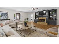 Bright and spacious living room featuring a fireplace and built-in shelving at 4340 Hadaway Nw Rd, Kennesaw, GA 30152