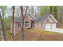 Charming brick home with attached two-car garage and mature trees at 240 Wrights Mill Way, Canton, GA 30115