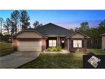 Charming brick home features a well-manicured lawn, attached garage, and welcoming entryway, perfect for suburban living at 313 Bonnie Sue Dr, Villa Rica, GA 30180
