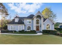Charming two-story traditional home featuring a well-manicured front lawn and a symmetrical facade at 700 Henley Fields Cir, Johns Creek, GA 30097