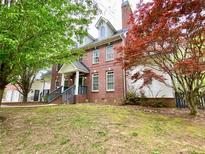 Beautiful brick home with a well-manicured lawn and mature trees at 2210 Holly Springs Rd, Rockmart, GA 30153