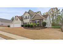 Two-story home with a two-car garage and well-manicured landscaping at 122 Crestmont Dr, Canton, GA 30114
