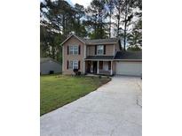 Charming two-story home with a well-manicured lawn and driveway at 230 Blue Heron Dr, Jonesboro, GA 30238