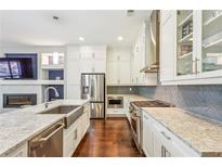 Bright kitchen boasts stainless steel appliances, a large island, and a modern design with custom backsplash at 828 Canterbury Overlook Ne, Atlanta, GA 30324