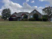 Charming single-story home with well-maintained lawn and mature trees, offering great curb appeal and a welcoming entrance at 140 Grayview Ct, Grayson, GA 30017