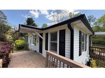 Charming house with black trim, black shutters and deck is bathed in natural light at 272 Old Sudie Rd, Hiram, GA 30141