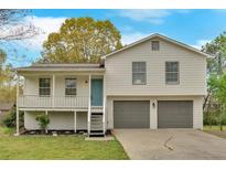Inviting two-story home featuring a charming front porch and a convenient two-car garage at 111 Evergreen Trl, Cartersville, GA 30121