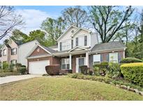 Charming two-story home with a brick facade, well-manicured lawn, and attached two car garage at 2798 Glenlocke Nw Cir, Atlanta, GA 30318