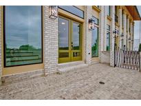 Beautiful entryway features a brick patio, stylish lighting fixtures, and double doors at 190 Rolison Way, Fayetteville, GA 30214