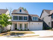 Charming two-story home featuring a white facade, black shutters, and a well-manicured lawn at 920 Wemberley Ln, Marietta, GA 30064
