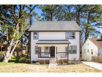 Charming two-story home with a welcoming front porch and beautifully maintained landscaping at 870 Gaston Sw St, Atlanta, GA 30310