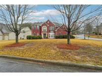 Beautiful red brick two-story home with mature trees and lush landscaping in a quiet neighborhood at 4419 Bellwood Cir, Atlanta, GA 30349