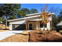 Charming modern home featuring sleek design, gray garage door, and tasteful landscaping at 2526 Abner Nw Pl, Atlanta, GA 30318