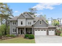 Charming two-story home with stone accents, three-car garage, well-manicured lawn, and lush landscaping at 2811 Shady Valley Ne Dr, Brookhaven, GA 30324