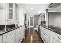 Modern kitchen features sleek white cabinetry, stainless steel appliances, and black marble countertops at 3435 Kingsboro Ne Rd # 603, Atlanta, GA 30326