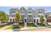 Charming townhomes featuring gray siding, white accents, well-maintained landscaping and sidewalk at 111 Chestnut Trce # 9, Hapeville, GA 30354