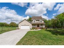 Charming two-story home featuring a covered front porch, attached garage, and a well-maintained lawn at 190 Ccc Rd, Kingston, GA 30145