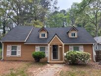 Charming single-story home featuring dormer windows, light-colored shutters and tidy landscaping at 2523 Hood Nw Ave, Atlanta, GA 30318