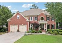 Charming brick home with manicured lawn, two-car garage, and inviting front entrance at 4062 Vinings Mill Se Trl, Smyrna, GA 30080