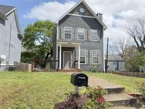 Charming two-story home with gray siding, shuttered windows, and a well-manicured front lawn at 810 Martin Se St, Atlanta, GA 30315