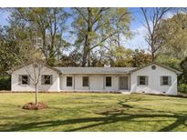 Charming one-story home with painted brick, gray shutters, mature trees, and a well-manicured lawn at 517 Toombs St, Palmetto, GA 30268