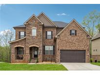 Charming two-story home showcasing a mixed brick and stone exterior with a well-manicured front lawn at 245 Piedmont Cir, Covington, GA 30016