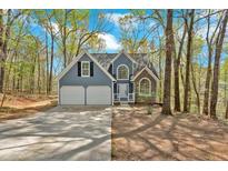 Charming, two-story home with a two-car garage nestled among trees at 4453 Autumn Glo Ct Ct, Douglasville, GA 30135
